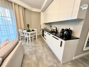 a kitchen with a couch and a table in a room at Apartament nad Łyną by RENT4YOU in Olsztyn