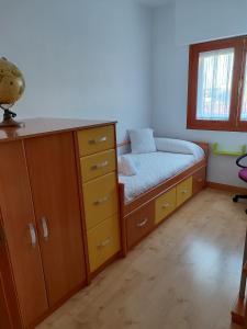 a bedroom with a bed and a dresser and a desk at Piso Igualdad in Toro
