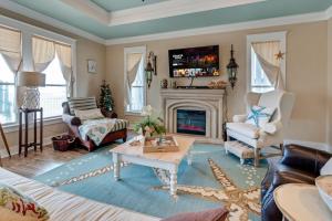 a living room with a couch and a fireplace at Hot Tub Golf Cart Near beach Coastal Retreat in Bolivar Peninsula