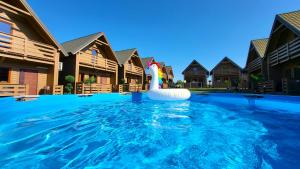 a pool with an inflatable swan in a resort at Seaside domki in Mielno