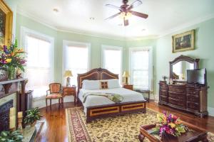 a bedroom with a bed and a ceiling fan at The Artist House in Key West