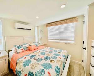 a bedroom with a bed and a window at Vacation Cottage North Myrtle Beach 67 in Myrtle Beach