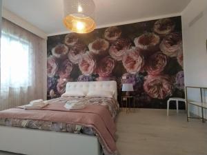 a bedroom with a mural of roses on the wall at B&B Potenza IT in Potenza