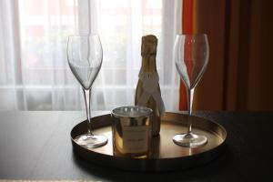a tray with two wine glasses on a table at B&B Potenza IT in Potenza
