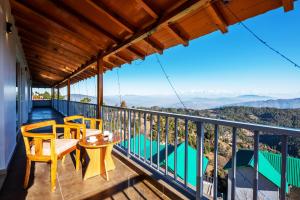 a balcony with a view of the mountains at Shree Parijat Resort At Mukteshwar Hill Station with Himalayan View in Mukteswar