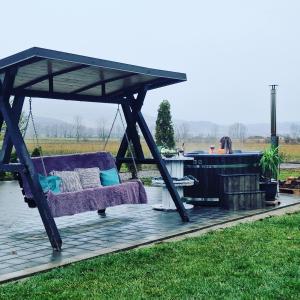 a couch sitting under a gazebo on a patio at Pensiunea Conacul lui Horia in Bistriţa