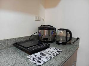 a coffee maker and a toaster on a kitchen counter at My Arezzo 1 BR Condo in Davao City