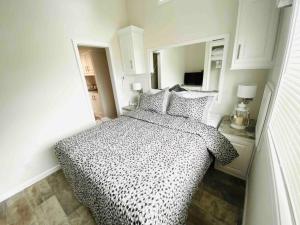 a bedroom with a black and white bed and a mirror at Vacation Cottages in North Myrtle Beach 66 in Myrtle Beach +14 photos