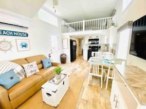 a living room and kitchen with a couch and a table at Vacation Cottages in North Myrtle Beach 66 in Myrtle Beach