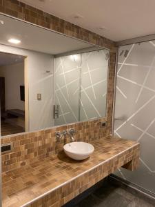 a bathroom with a sink and a mirror at Adobe Suites in Salta