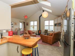 a kitchen and living room with a table and chairs at New Heights in Keighley