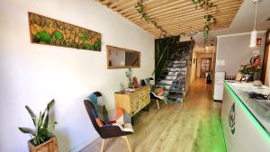 a living room with a staircase in the background at Eco Hotel Toledo in Toledo