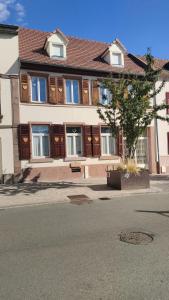 une grande maison avec des portes en bois dans une rue dans l'établissement "Coeur d'elsass"Colmar centre bel appartement avec parking privé, à Colmar