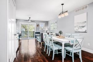a dining room with a white table and chairs at Lakescape, Modern 3BD Townhome Near Downtown and Wineries in Traverse City