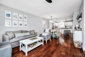 a living room with a couch and a table at Lakescape, Modern 3BD Townhome Near Downtown and Wineries in Traverse City