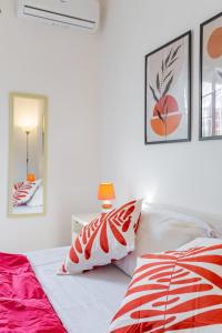 a bedroom with a bed with red and white pillows at Milvio Bridge - cozy apartment in Rome in Rome