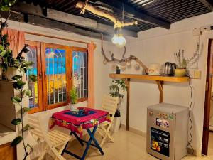 a kitchen with a table and chairs and a window at HÙNG Apartment Dalat in Da Lat