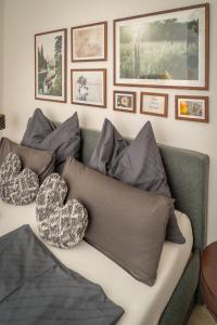 eine Couch mit Kissen drauf mit Bildern an der Wand in der Unterkunft Walters Appartment - Wohfühlurlaub für Mensch und Hund in Anif