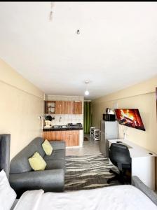 a living room with a couch and a desk at SABU HOMEs in Nairobi