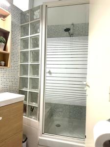 a shower with a glass door in a bathroom at Studio, Sea and the Beach in Le Havre