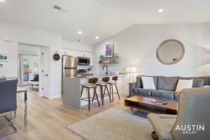 a living room with a couch and a kitchen at Close to Barton Springs and Zilker w King BR and Patio in Austin