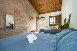 Postel nebo postele na pokoji v ubytování Recanto de tranquilidade próximo a Morro e Boipeba. Casa espaçosa com piscina a 5 minutos a pé da Praia.