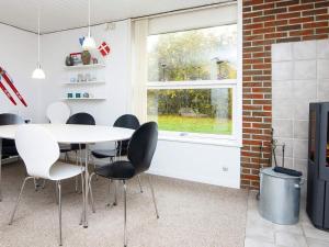 a dining room with a table and chairs and a window at 6 person holiday home in Hemmet in Hemmet