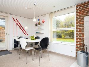 a dining room with a table and chairs and a window at 6 person holiday home in Hemmet in Hemmet