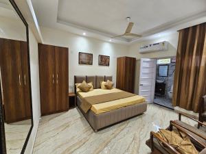 a bedroom with a large bed and a bathroom at Ankhi's Villa with Parking in Amritsar