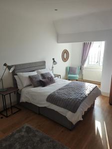 a bedroom with a large bed and a window at White House in Lytham St Annes