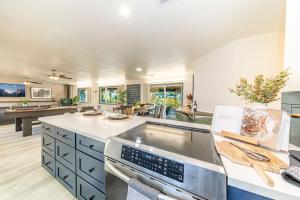 a large kitchen with blue cabinets and a stove top oven at Starry Night Cabin at Sky Ranch in Oakhurst