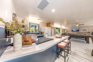 a kitchen with a counter with a vase of flowers at Starry Night Cabin at Sky Ranch in Oakhurst +41 photos