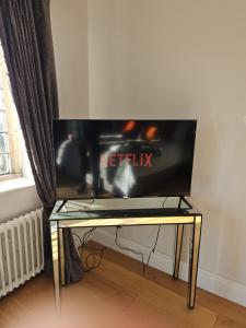 a tv sitting on top of a glass table at White House in Lytham St Annes