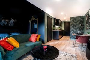 a living room with a couch and a table at L'Insoupçonnée in Nantes
