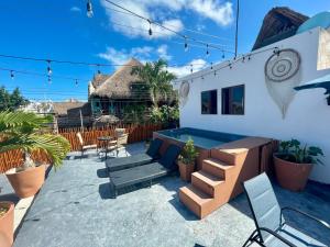 a patio with chairs and a table and chairs at Balam Holbox in Holbox Island