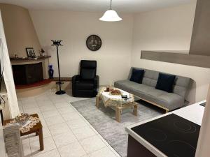 a living room with a couch and a table at Palaiomonastiro mountain resort 1 