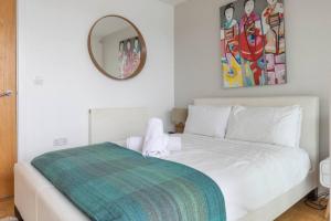 a bedroom with a white bed and a mirror at Skylark Lodge HM24 HOT TUB Lakeside Spa in Somerford Keynes +47 photos