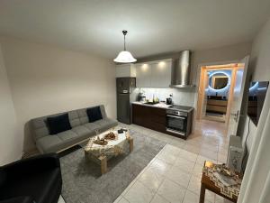 a living room with a couch and a kitchen at Palaiomonastiro mountain resort 1 in Palaiomonástiron