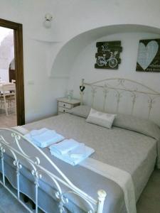 um quarto com uma cama com duas toalhas em Trulli Manuela (il fragno) em Locorotondo