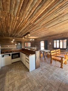 a kitchen and dining room with a wooden ceiling at Pousada Costaneira in Cambará