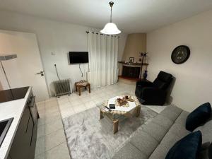 a living room with a couch and a table at Palaiomonastiro mountain resort 1 in Palaiomonástiron
