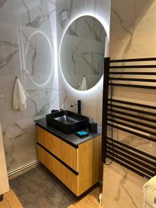 a bathroom with a sink and a mirror at Palaiomonastiro mountain resort 1 