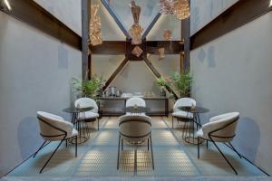 a group of chairs and tables in a room at MX Grand Suites in Mexico City