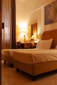 Postel nebo postele na pokoji v ubytování Hotel Giotto Flavia