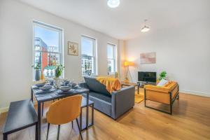 a living room with a couch and a table at Spacious City Centre Apartment - Sleeps 8 in Liverpool