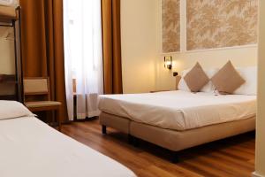 Postel nebo postele na pokoji v ubytování Hotel Giotto Flavia