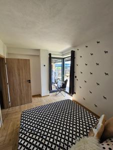 a bedroom with a bed with a black and white rug at Vila Leo in Donovaly