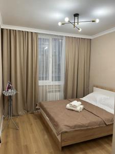 Ένα ή περισσότερα κρεβάτια σε δωμάτιο στο 2х комнатная квартира Астана Левый берег