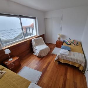 a bedroom with two beds and a window at Casa Sonho Azores - AL 1449 in Ponta Delgada