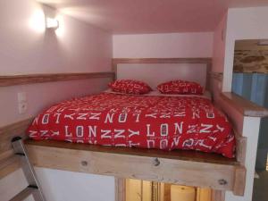 uma cama com cobertores e almofadas vermelhos e brancos em Le Rhône à vos pieds, Bellecour à quelques pas em Lyon